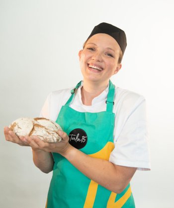 Twelve 15 chef manager holding a loaf of bread